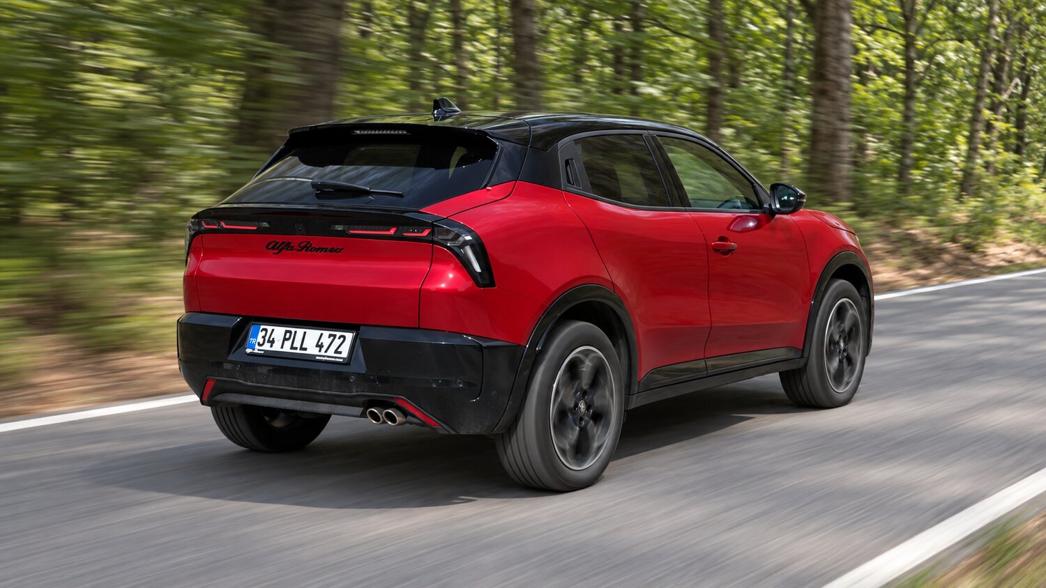 Kırmızı Alfa Romeo Junior Ibrida Speciale+ orman yolunda sürüş